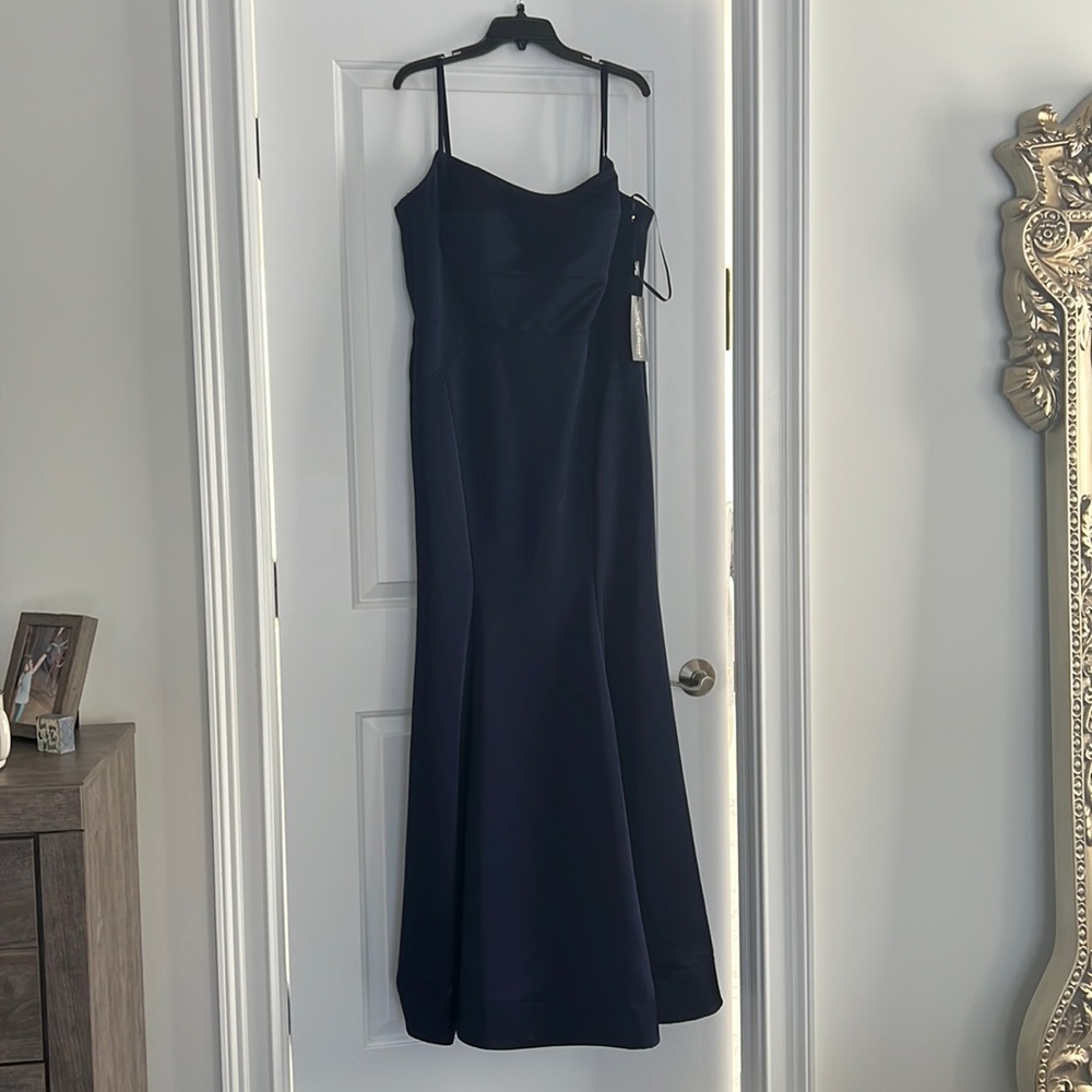 Floor length gown in Navy size 14. New with tags. Brand is La Femme.